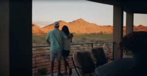 couple enjoy beautiful Southern Utah sunset from custom home patio in St George, UT
